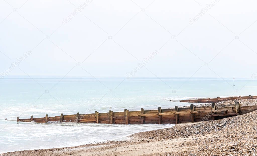 A view of the high tide and tidal poles at the seaside, Worthing, UK
