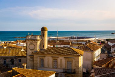 The sunset view of Saintes-Maries-de-la-Mer,  the capital of the Camargue in the south of France clipart