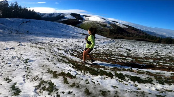 young woman running in the mountains