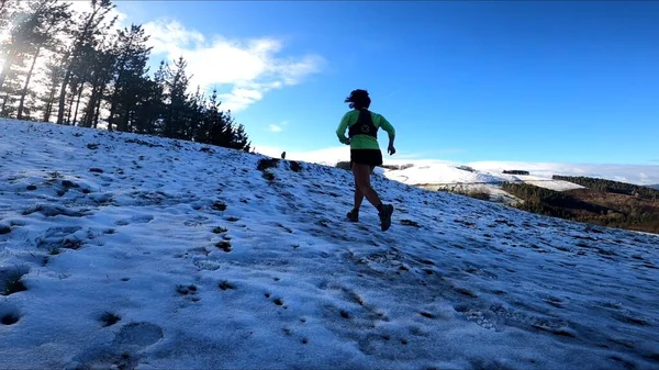 young woman running in the mountains