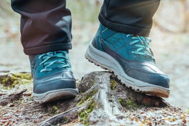 Ormanda yürüyüş parkurunda kadın yürüyüşçü, ayakların ve botların zemininden manzara