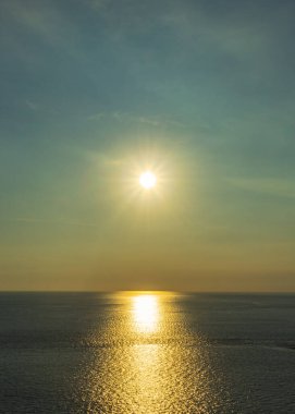 Güzel gün batımı kumsalı, okyanus suyu ve gökyüzü, altın saatinde basit bir resim.