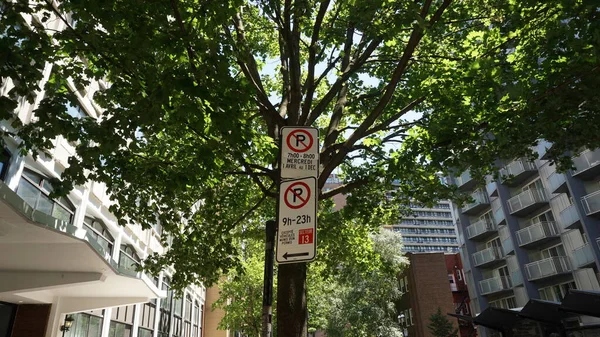 Montreal, QC- Canada - 6-24-2020: Parking challenge in downtown. No Parking signs: top (Wednesdays from 7:00 to 8:00 AM, from Apr 1st to Dec 1st), bottom (9:00 AM to 11:00 PM except for sector 13) — Stock Image Montreal Canada 2020 Parking Challenge Downtown Parking Signs Top Wednesdays Stock Picture
