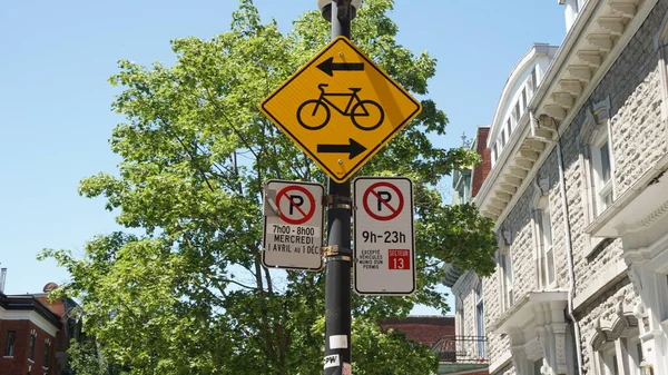 Montreal, QC- Canada - 6-24-2020: Parking challenge. Cycle sign and No Parking signs: left: Wednesdays from 7:00 - 8:00 AM, from Apr 1st to Dec 1st, right: 9:00 AM to 11:00 PM except for sector 13. — Stock Image Montreal Canada 2020 Parking Challenge Cycle Sign Parking Signs Left Royalty Free Stock Images