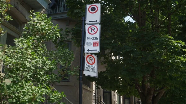 Montreal, QC- Canada - 6-24-2020: Parking challenge in downtown. No Parking signs: bottom (Wednesdays from 7:30 to 8:30 AM, from Apr 1st to Dec 1st), middle(9:00 AM to 11:00 PM except for sector 13) — Stock Image Montreal Canada 2020 Parking Challenge Downtown Parking Signs Bottom Wednesdays Stock Image