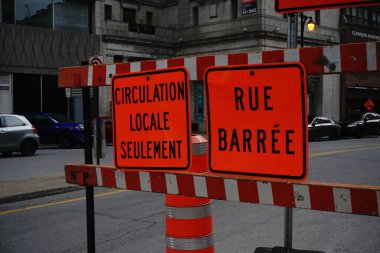 Montreal, QC, Canada - 7-15-2021: In French Right: A sign of closed street. Left: Only local circulation is allowed.
