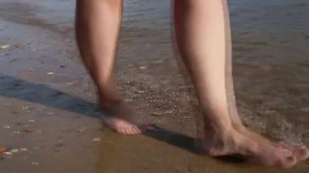 Mujer caminando en la playa soleada — Vídeo de stock