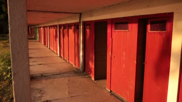 Deserted locker room cabins on the lake — Stock Video