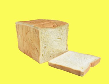 Tost ekmeği ya da dilimlenmiş sandviç kesme yolu ile izole edilmiş ekmek, sarı arka planda gölge yok.