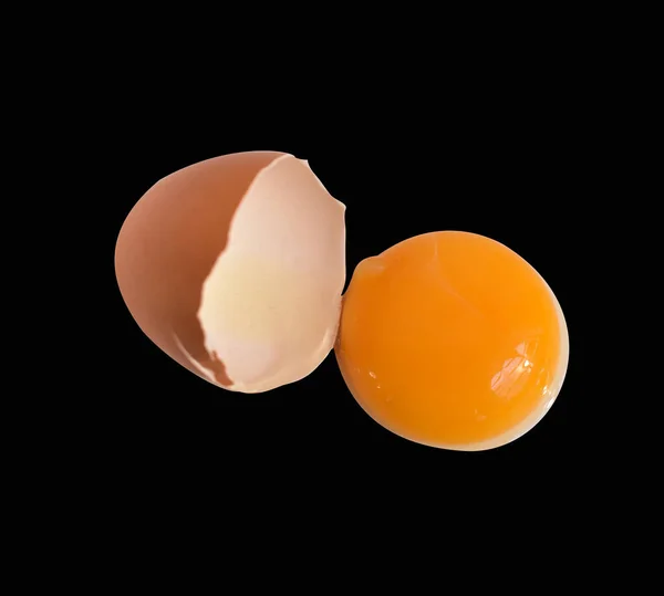 真正的鸡蛋 褐色的半碎蛋 蛋黄与切割路径 没有阴影在黑色背景 — 图库照片