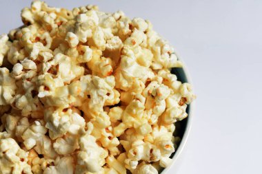 Beyaz arka planda izole edilmiş patlamış mısır kasesi, tatlı tereyağı veya karamelli patlamış mısır, tuzlu