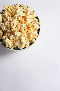 Beyaz arka planda izole edilmiş patlamış mısır kasesi, tatlı tereyağı veya karamelli patlamış mısır, tuzlu