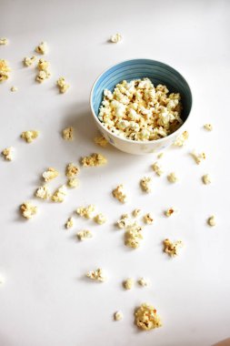 Beyaz arka planda izole edilmiş patlamış mısır kasesi, tatlı tereyağı veya karamelli patlamış mısır, tuzlu