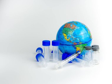 Aşı şişesi ve dünya modeli beyaz arka plana yerleştiriliyor. Corona virüsü konsepti