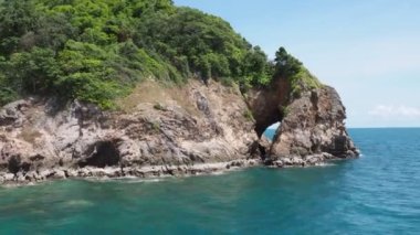 A view from passenger ferry of the blue sea and the island in the middle of the sea.