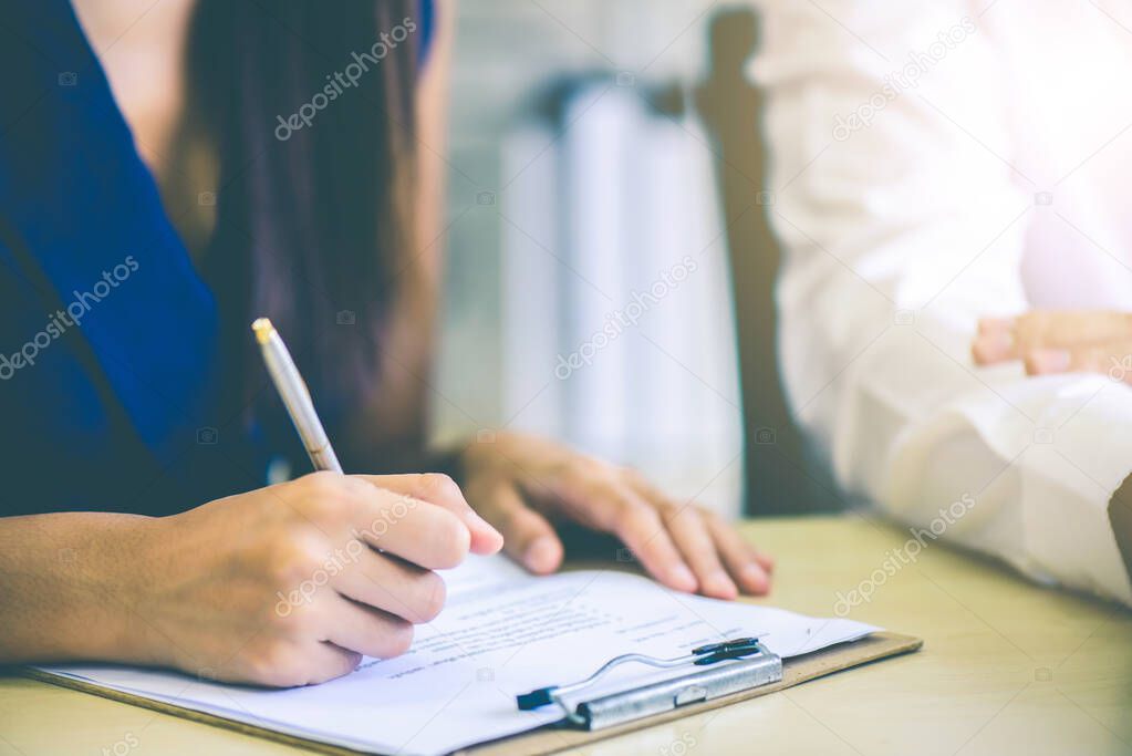 Hand of business woman or secretary take note on paperwork or sign contact while business meeting at office, business financial presentation conference concept 