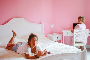 Laptop ve cep telefonu kullanan iki çalışan kadın. Modern iş hayatı