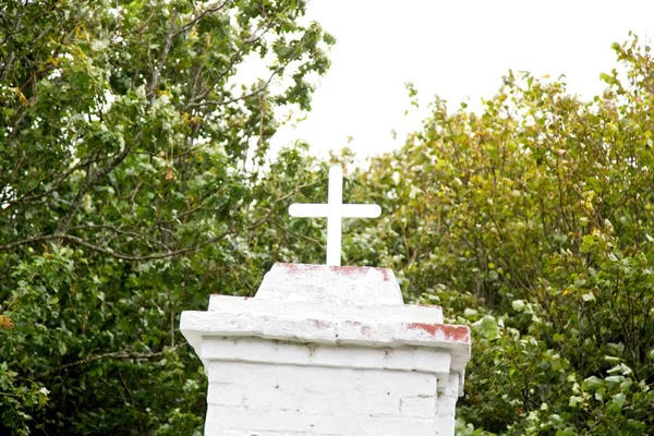 old wooden cross on the background of the cemetery