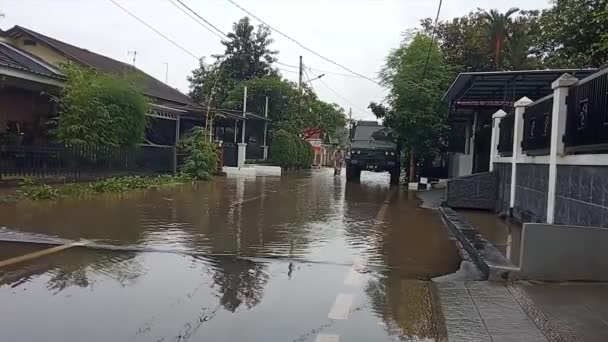 2021年2月20日インドネシアのコンデ東ジャカルタの洪水の小さな通りを横断するオートバイ — ストック動画