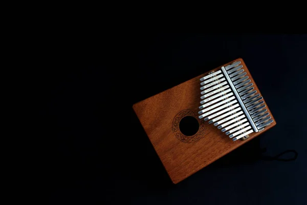 Kalimba, acoustic music instrument from africa and its soft cover at Black Background with negative or copy spac