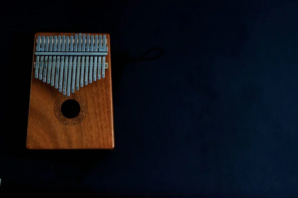 Kalimba, acoustic music instrument from africa and its soft cover at Black Background with negative or copy spac