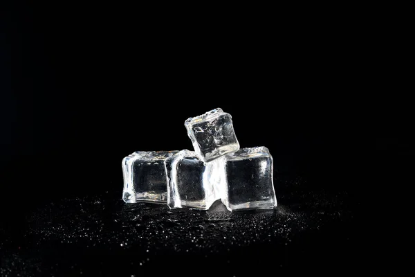 5 wet artificial or fake ice cube at Black background