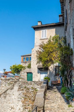 Corenno Plinio with stone houses, plants and flowers