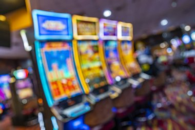 Soyut, bulanık kumarhane içi renkli kumar makinesi ışıkları eğlence konsepti tasarımı için canlı oyun ortamı yaratıyor arka planda dijital, yaratıcı görsel kullanım