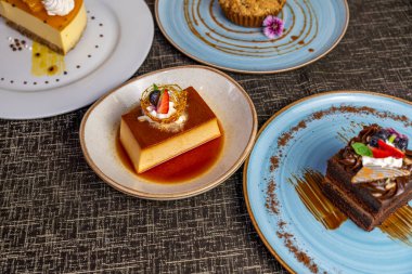 Krem şantili ve taze meyve garnitürlü karamel flan tatlısı. Restoran ve otel tatlı menüleri için zarif bir sunumla gurme kreması..