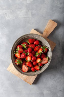 Gri arka planda taze çilekler. Üst görünüm.