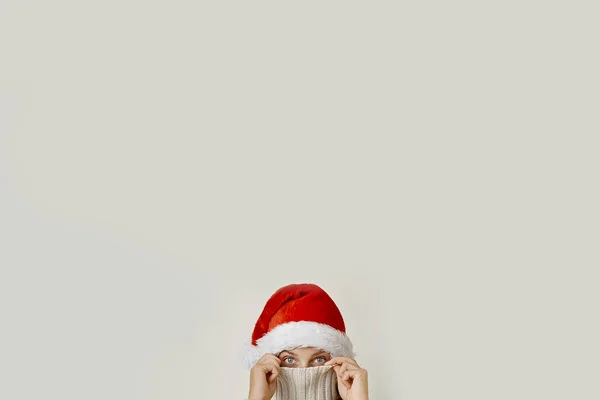 Concept of a woman in santa hat covering his face with a collar — Stock Photo, Image