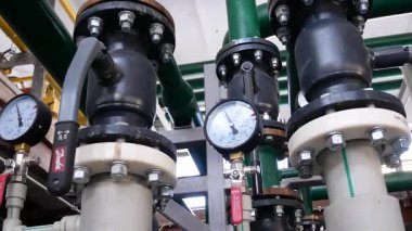 Boruları, kapama vanaları ve basınç sensörleri olan mini kazan dairesi ekipmanlarına yakın çekim. Yerleşim bölgelerine termal enerji üretimi ve tedariği için sanayi sistemi