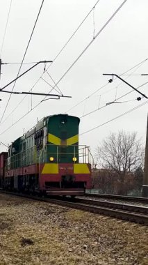 Kharkiv, Ukraine - Nowember, 12, 2024: Freight train travels by rail, many wagons. Freight transportation by rail.