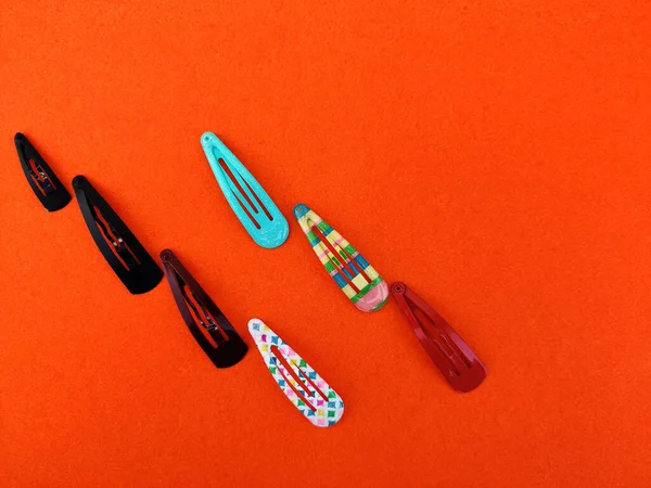 Various Colored Trendy Hair Clips Isolated Orange Background — Stock Photo, Image