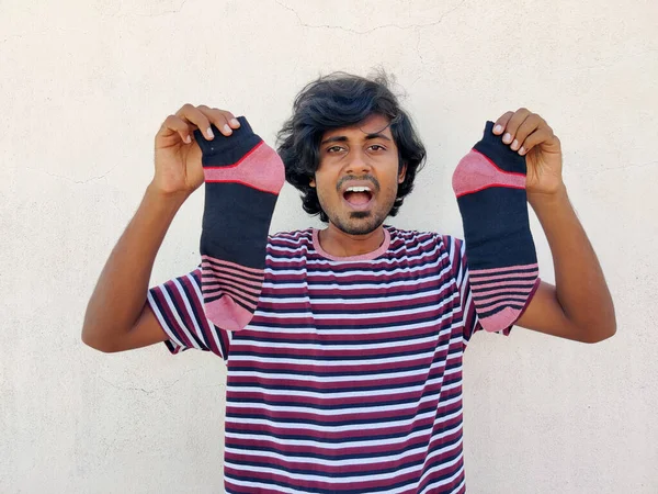 Super Excited Young Man Holding Pair Stripped Socks Atlast Found — Stockfoto