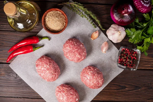 Scotch eggs. Soft boiled eggs with runny yolk wrapped in minced meat. Served with spiced green on a wood tray, view from above. Flat lay