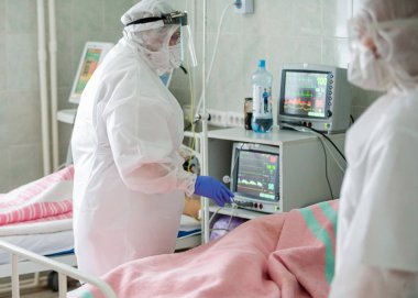  Koronavirüs salgınının ortasında COVID-19 enfeksiyonu olan hastaları tedavi eden acil servis hastanesinde koruyucu kıyafetli bir sağlık görevlisi. 