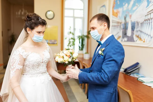 people wear medical masks to each other, care for the health of a loved one during a pandemic, safety and hygiene in a protective mask and gloves
