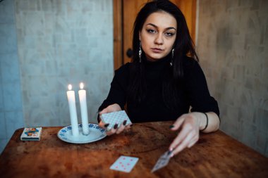 Falcı geleceği tahmin etmek için kartları karıştırıyor.