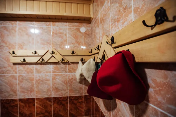 bath hats hang on a hanger. steam room of the hot sauna for wellness recreation.