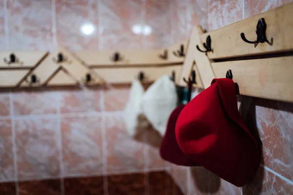 bath hats hang on a hanger. steam room of the hot sauna for wellness recreation.