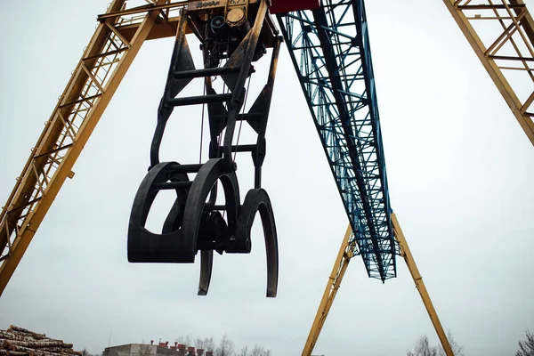 the gantry crane works by grabbing heavy loads in the factory. automated transportation of multi-ton objects in industry