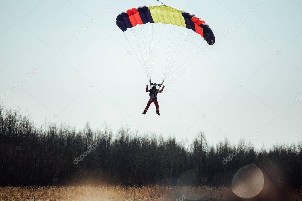 skydivers jump out of the plane from a great height. the adrenaline of extreme sports. skydiver in free fall against a clear blue sky
