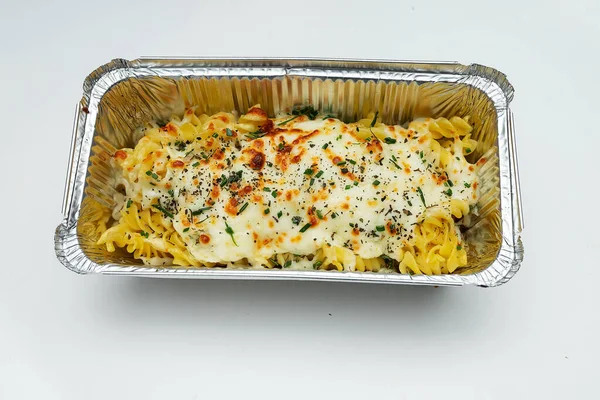 hot pasta from pasta with seafood prepared in a fast food restaurant and Packed in disposable dishes for quick delivery, one container is open and the second is closed