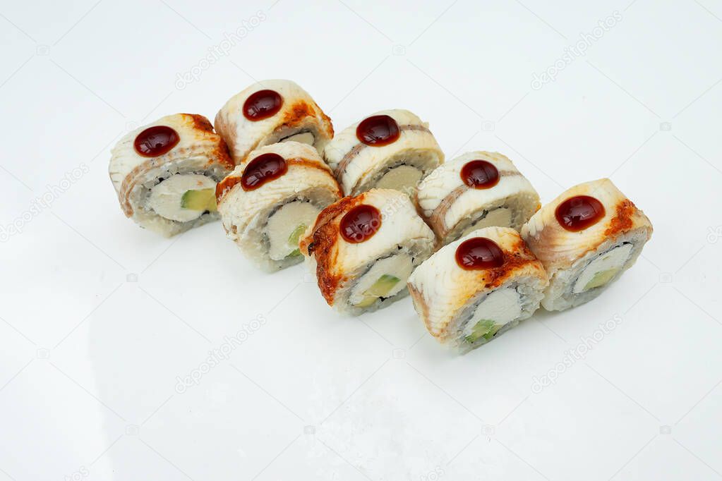 a portion of sushi rolls is on the table on a white background, a prepared Asian dish of seafood and fresh rice, delicious food