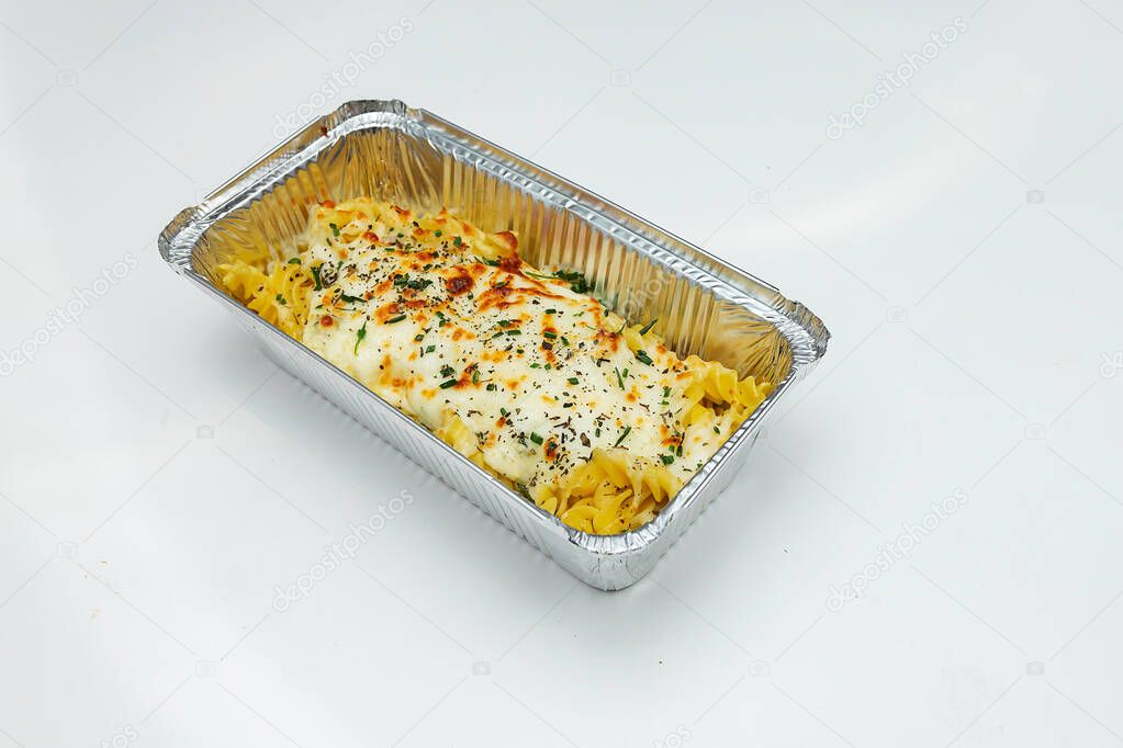 hot pasta from pasta with seafood prepared in a fast food restaurant and Packed in disposable dishes for quick delivery, one container is open and the second is closed