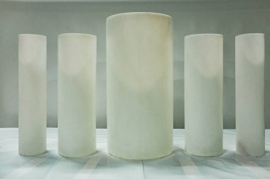 Farklı çaplarda siyah silindirik plastik borular stokta. Boru tesislerinin ürünlerinin sergilenen örnekleri. Yeraltı hizmetleri için polimer borular