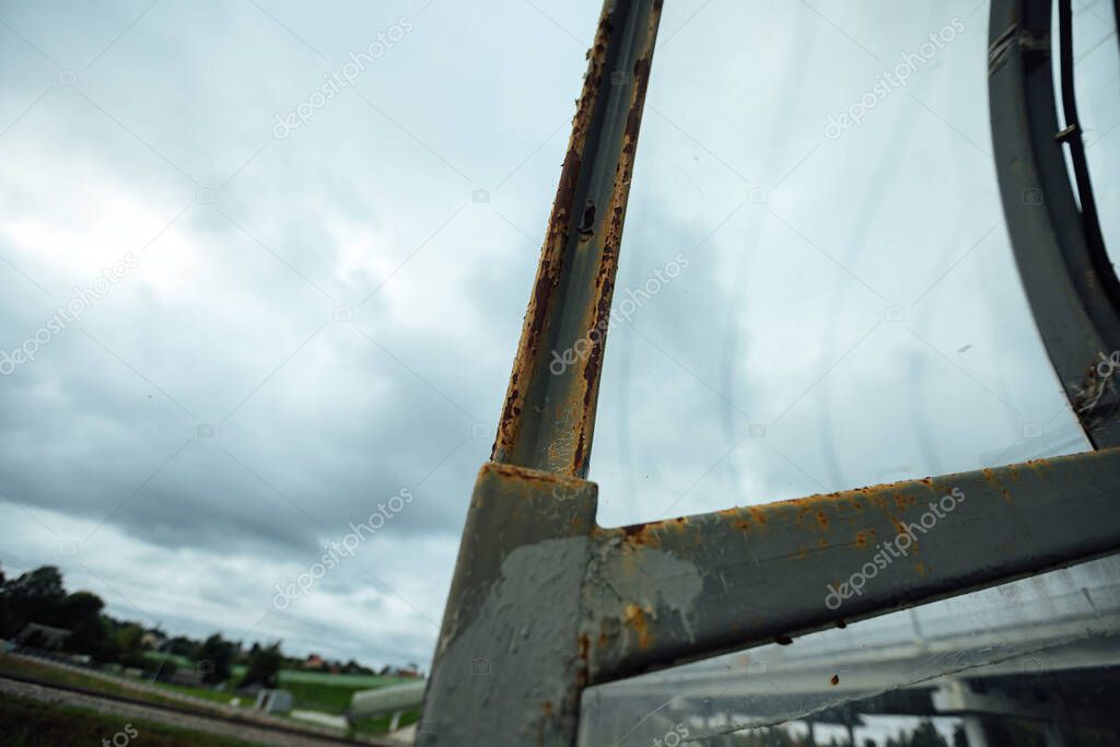 rusty handrails of pedestrian bridge supports. metal elements of the bridge damaged by corrosion. metal poles that have fallen into disrepair require repair