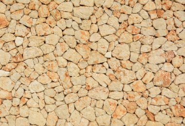 Doğal taş duvar, kum rengi dokusu.
