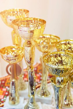 Bir sergi veya spor müsabakasında kazananları tebrik etmek için altın kupalar.